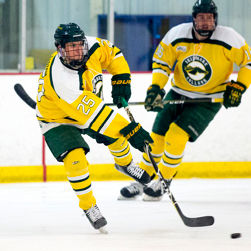 two Skidmore hockey players passing the puck