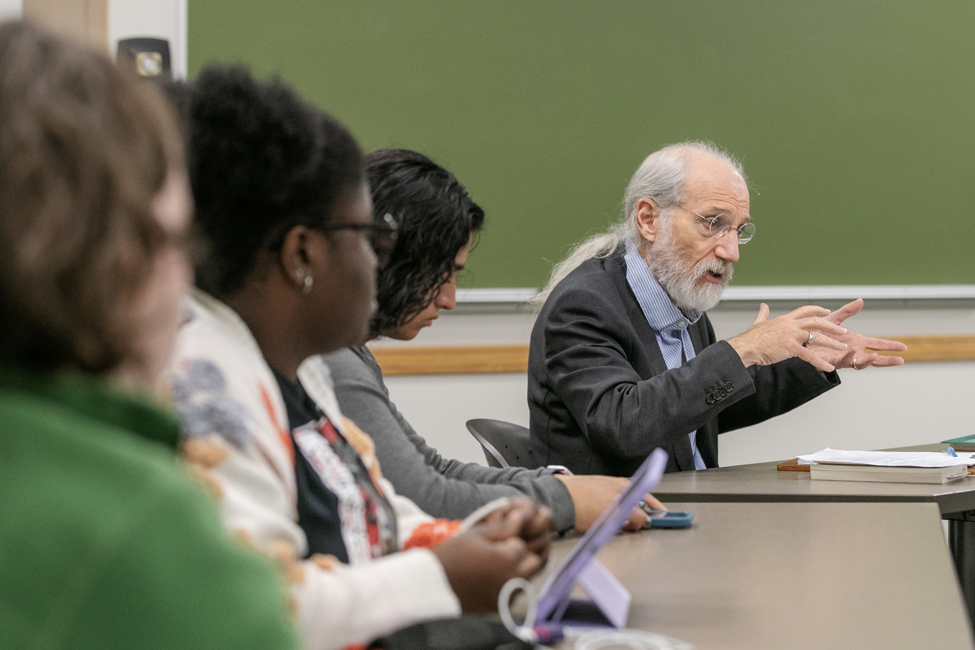 Professor Michael Marx gestures enthusiastically as his Scribner Seminar students watch.